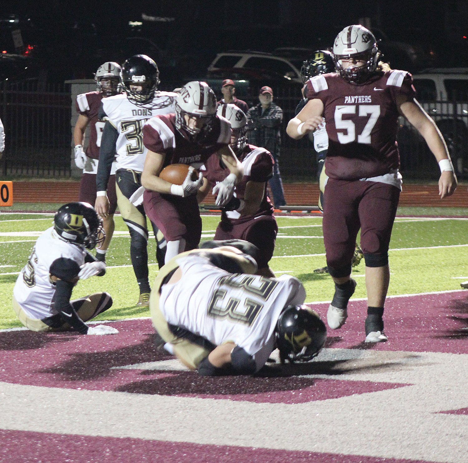 Mountain Grove’s Deveyn Martin plows into the end zone as two Doniphan players lay on the ground in the end zone.